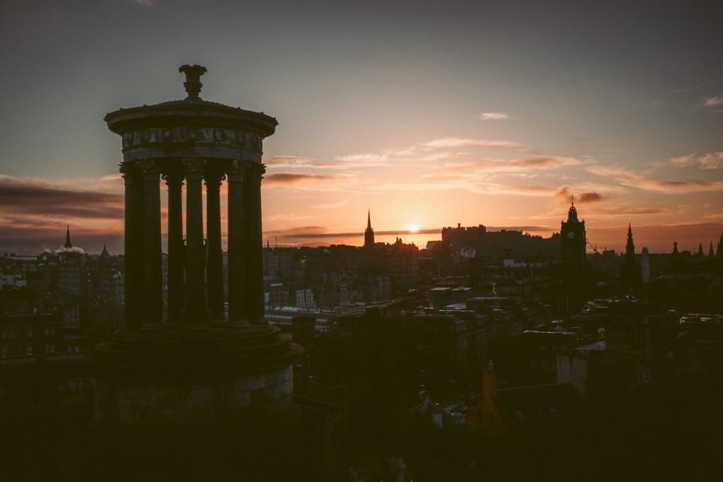 Sunset over Edinburgh from Calton Hill, with the Dugald Stewart Monument in silhouette.