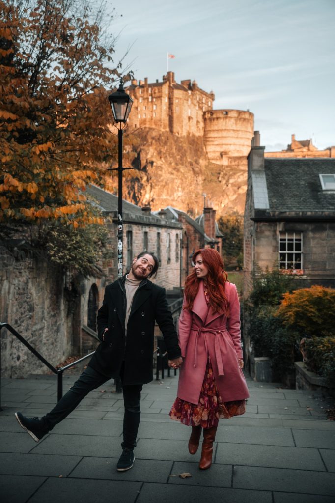 Couple laughing on the Vennel steps below Edinburgh Castle in autumn.
