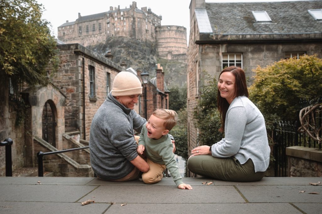 Family laughing with their young son on the Vennel steps below Edinburgh Castle
